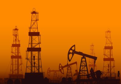 Drilling rigs and oil pumps at orange sunset in desert. Detail vector illustration.